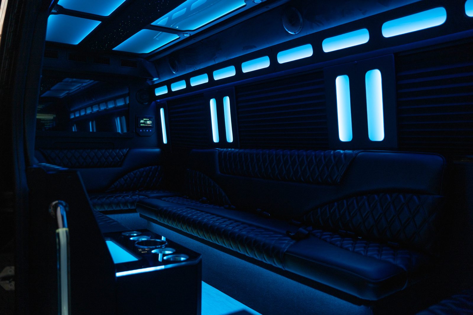 Limo Sprinter interior with blue LED accent lighting and wraparound seating