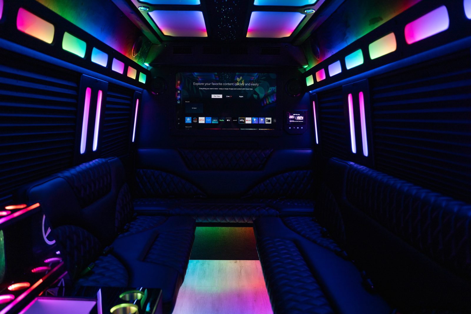 Limo Sprinter interior with wraparound seating and color lighting