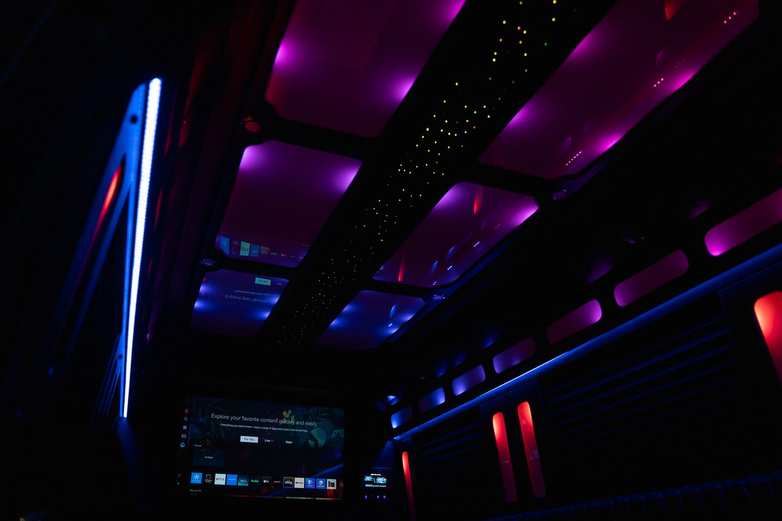 Limo Sprinter interior with purple ambient lighting and mirrored ceiling