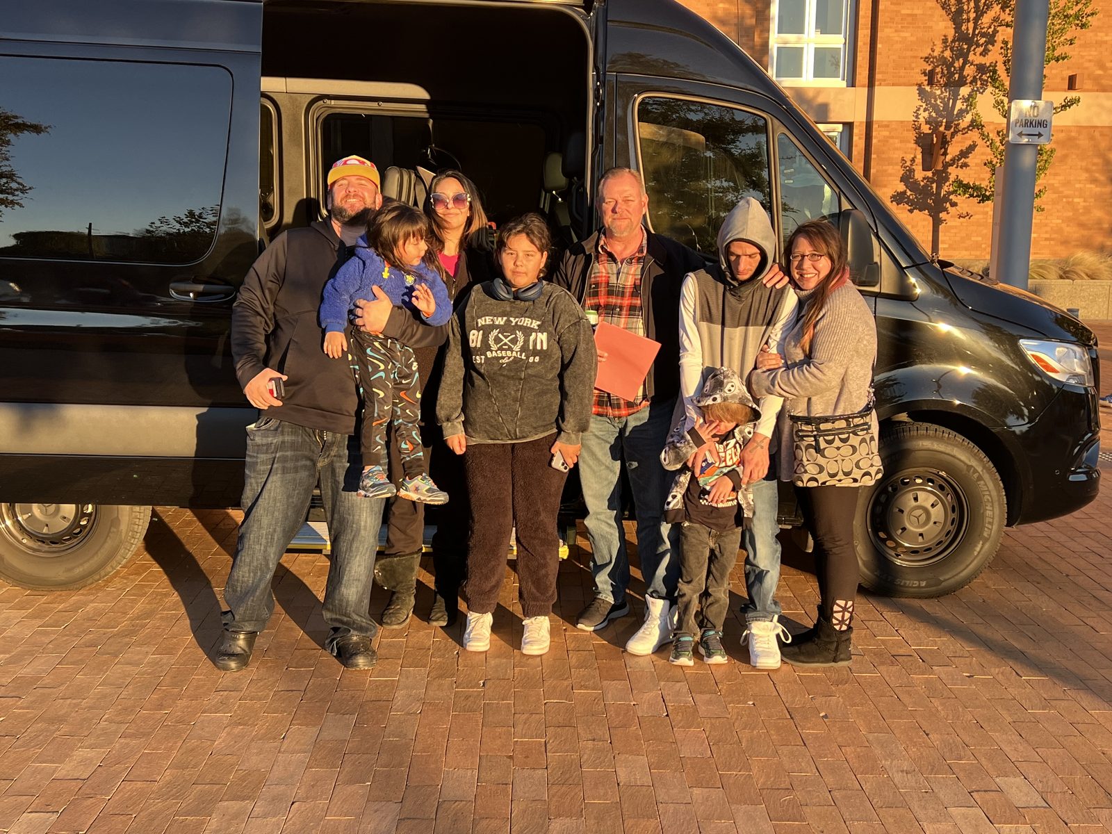 Family group with children posing in front of a Sprinter